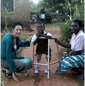 An inspiring story: Christine Gibbard, pictured in Kenya with Sharon, a little girl who needed an operation before getting prosthetic legs. Sharon has done well and can now walk.